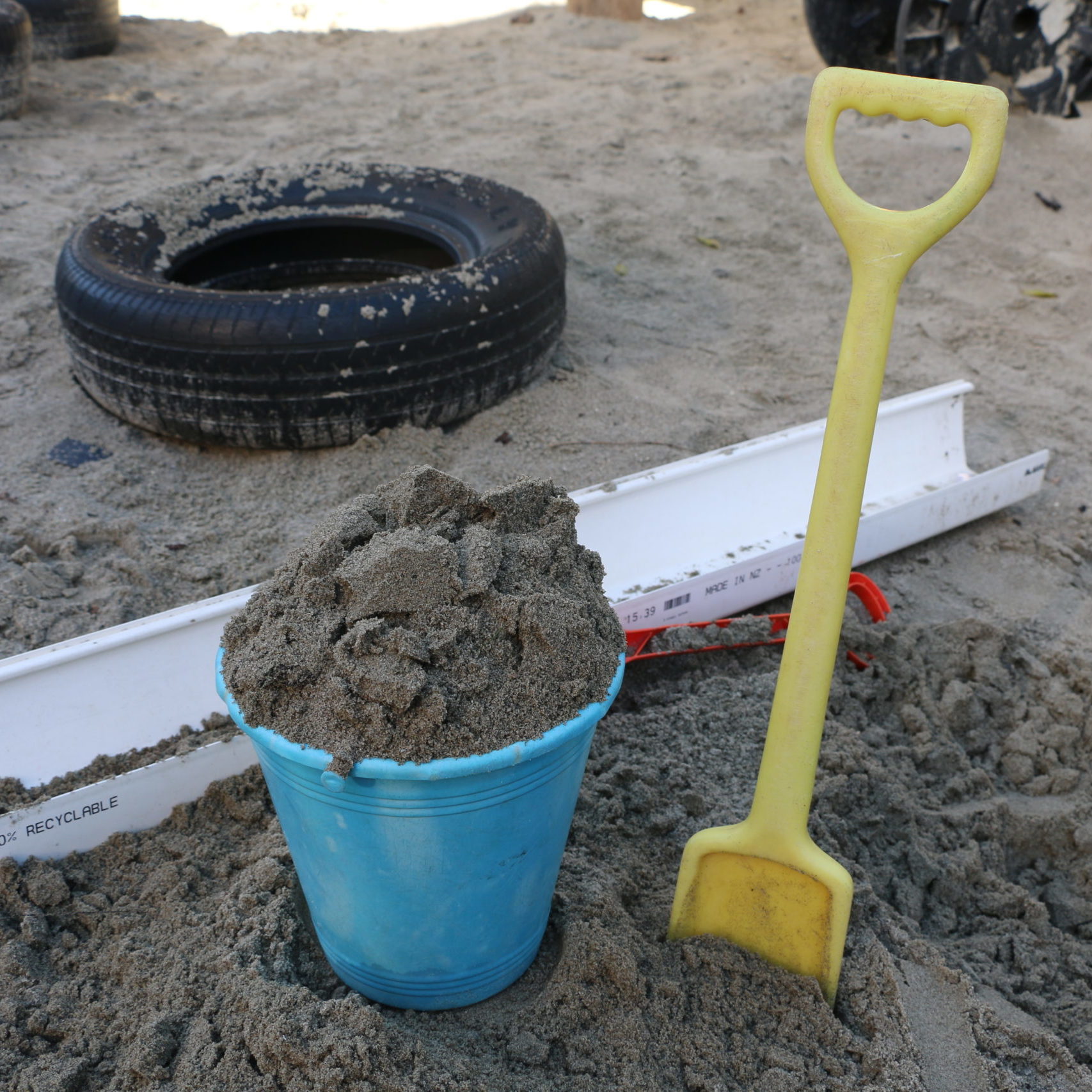 sandpit with bucket, spade, and other sandpit toys