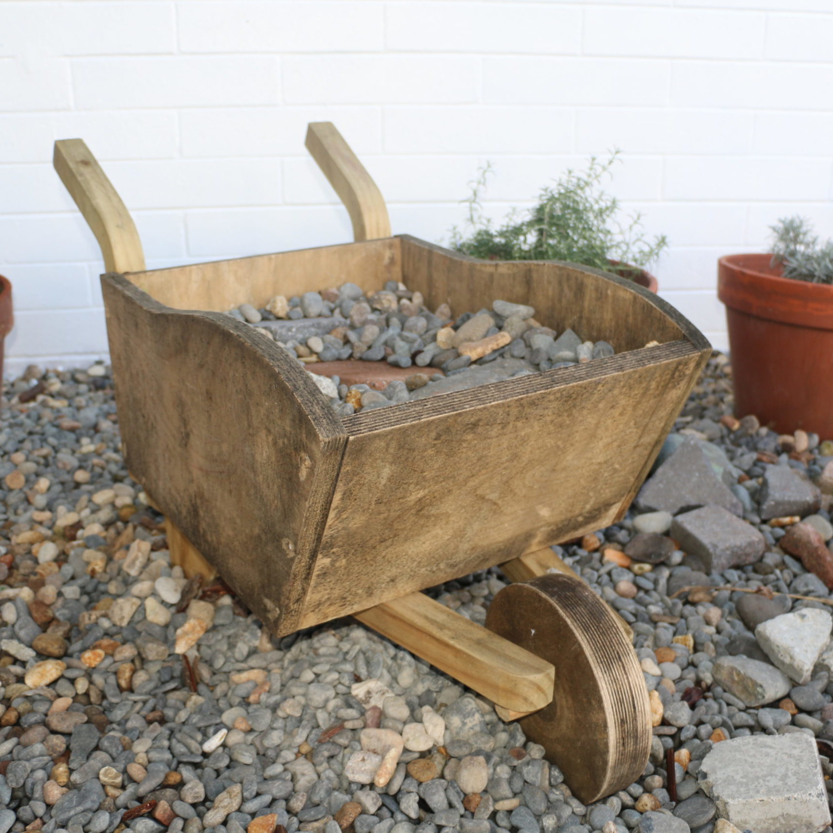 Wooden wheelbarrow filled with rocks