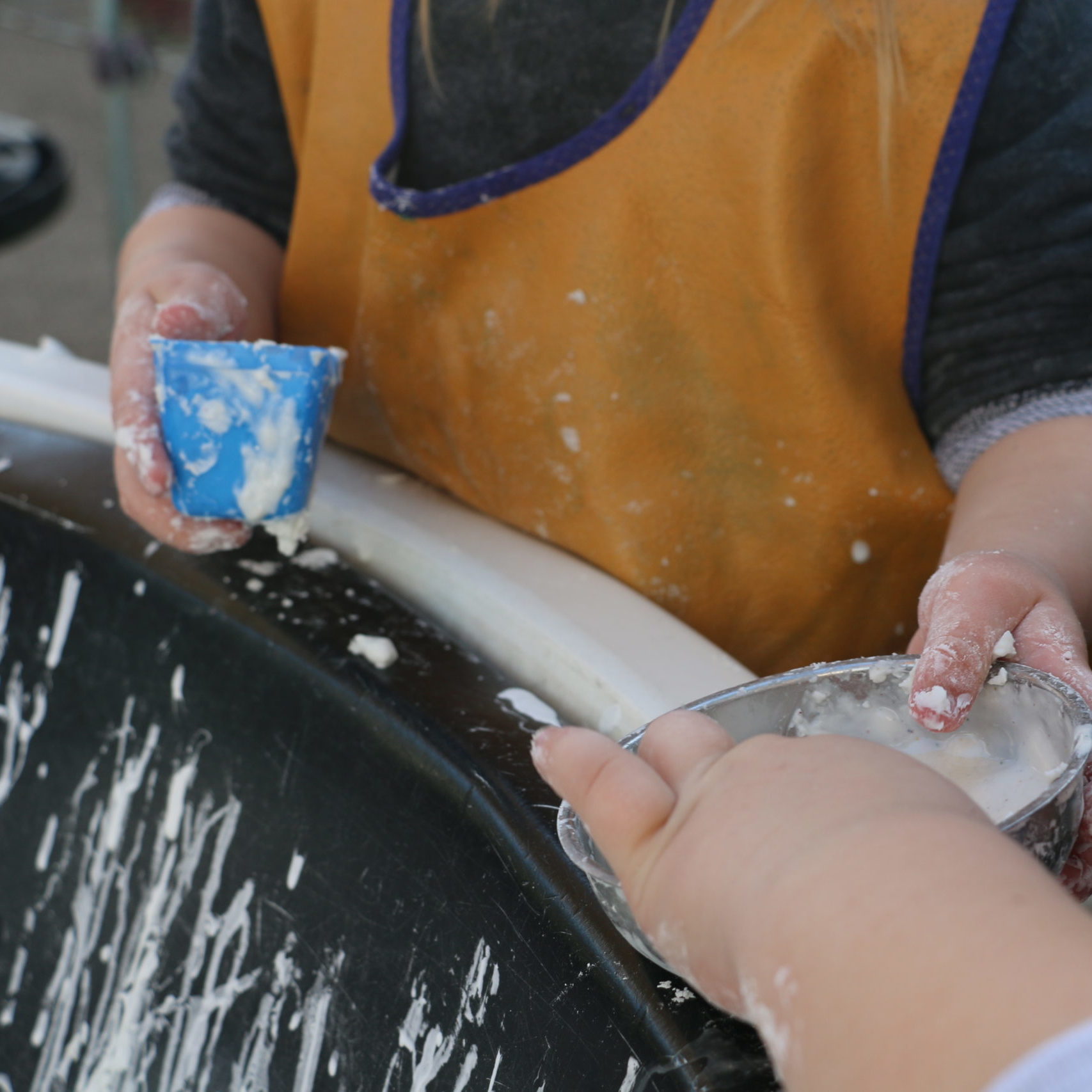 Children sharing gloop in their bowls
