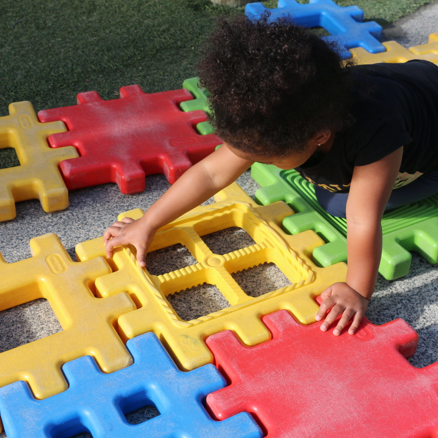 child playing with large plastic blocks
