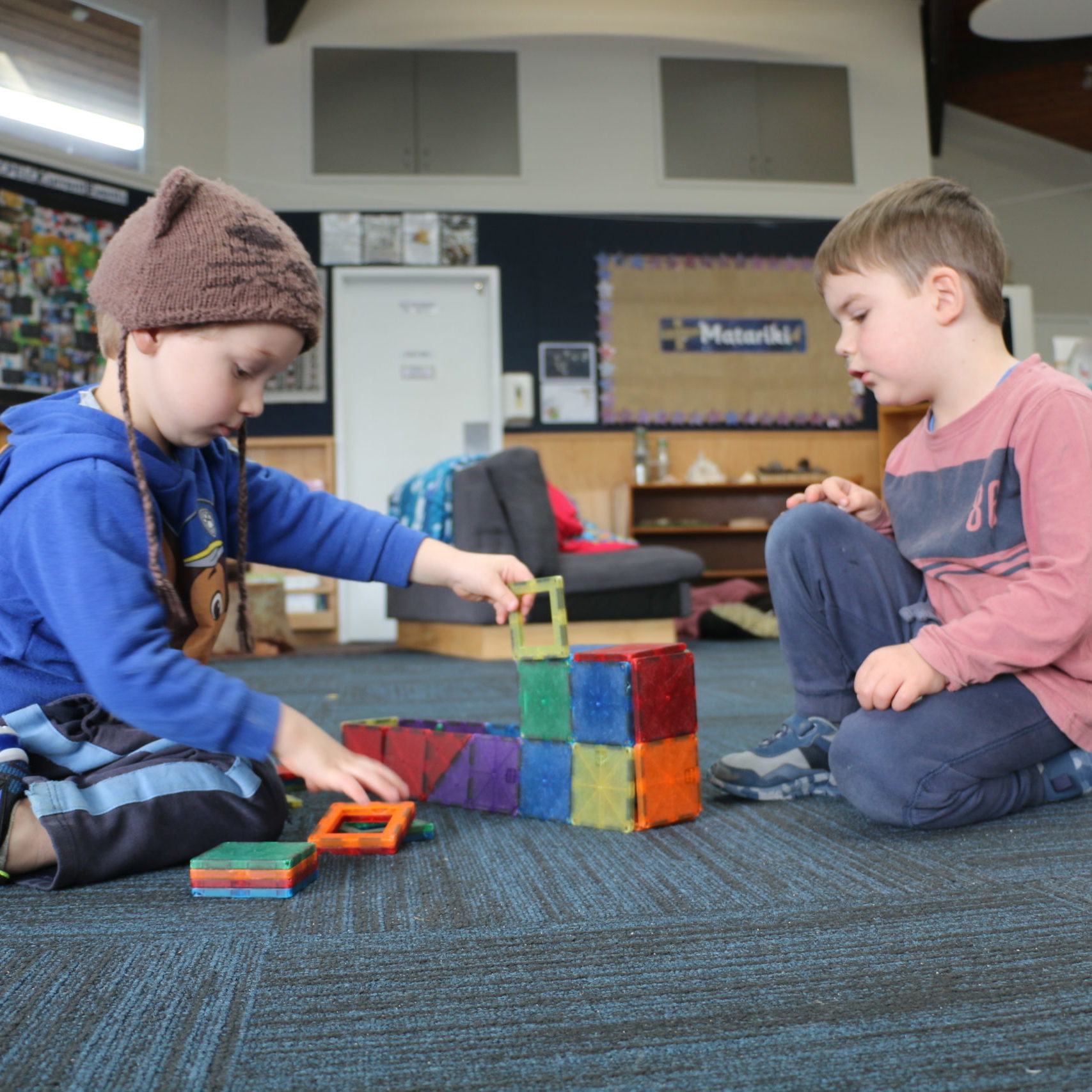 Children playing with magnetic blocks