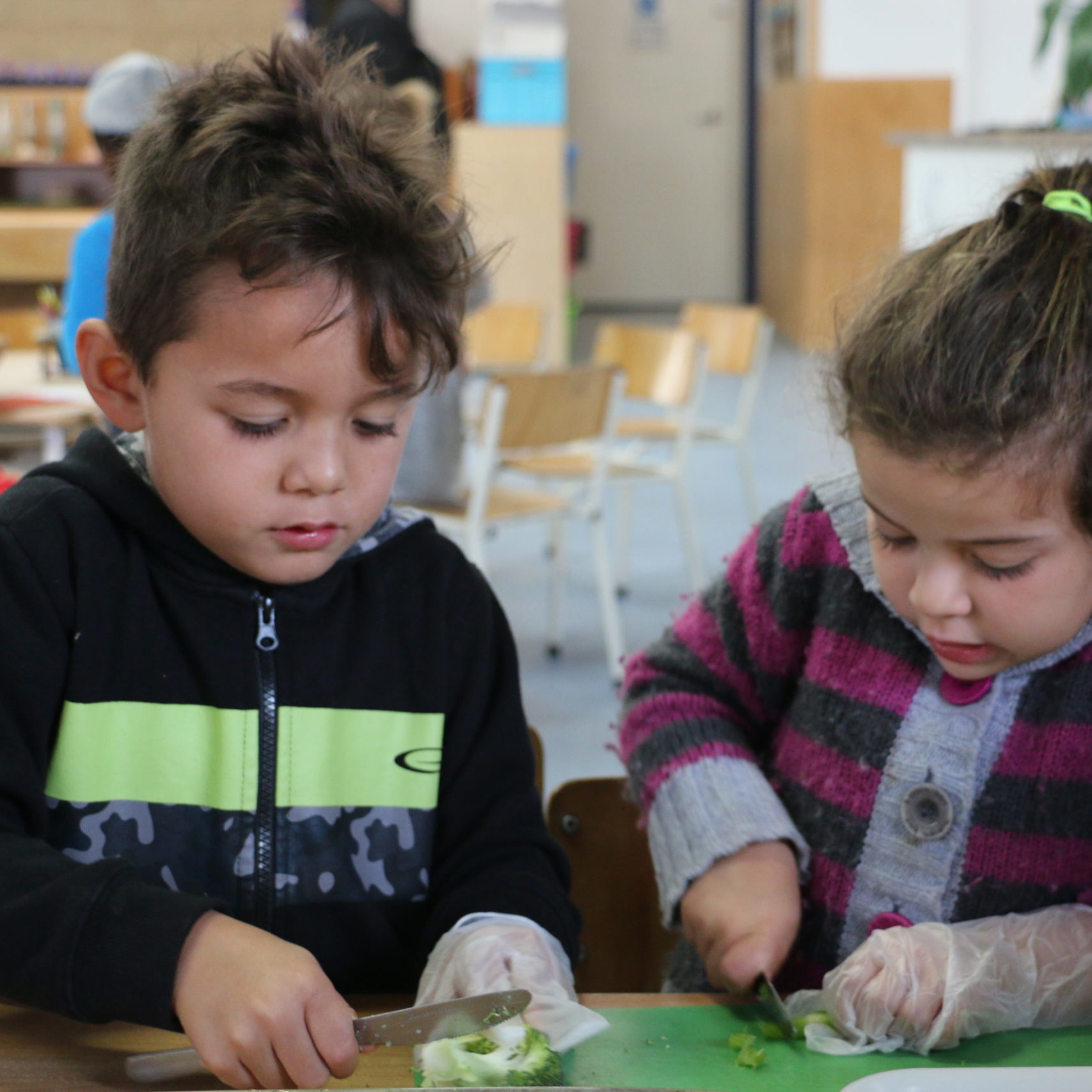 Children cutting vegetables