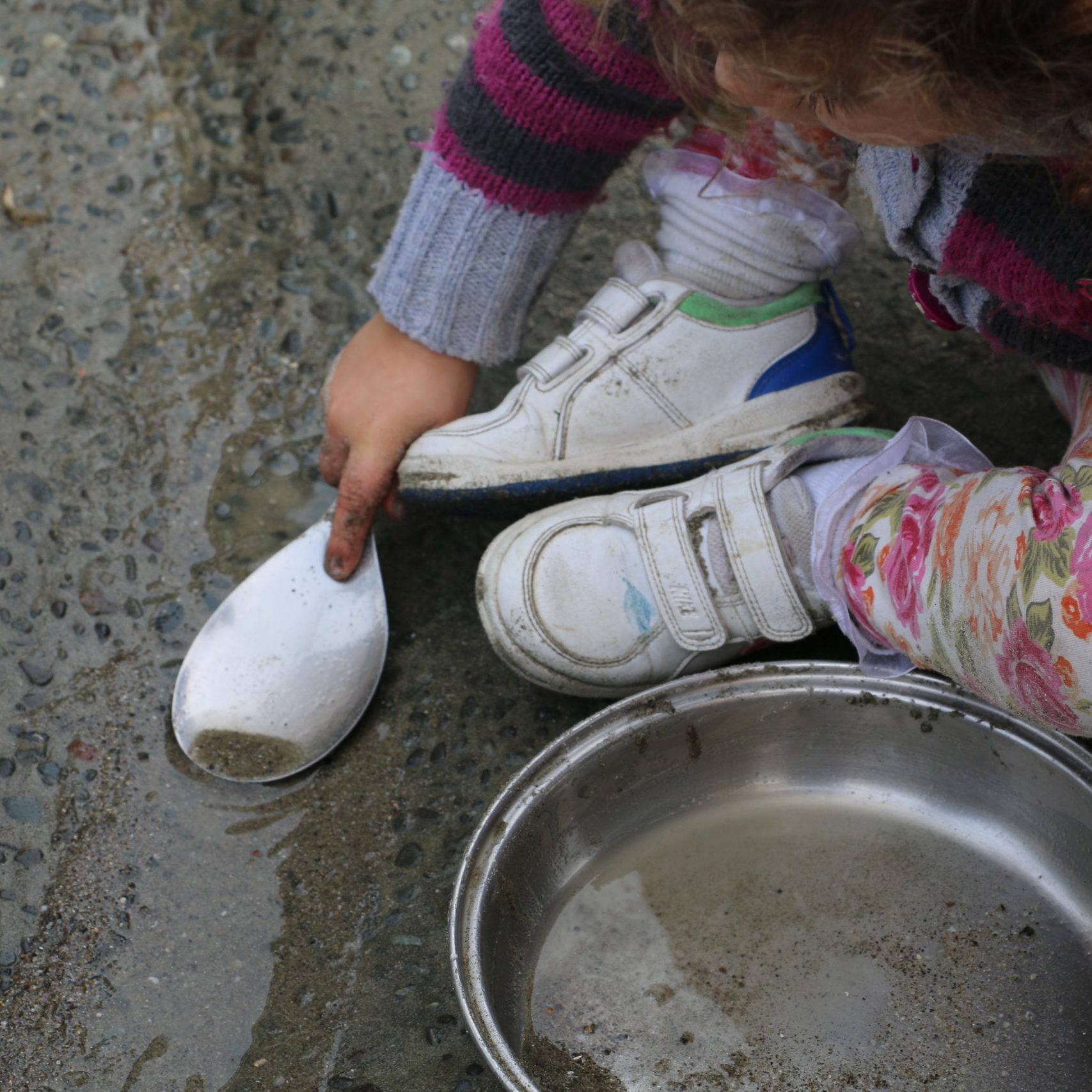 child playing with sand and water