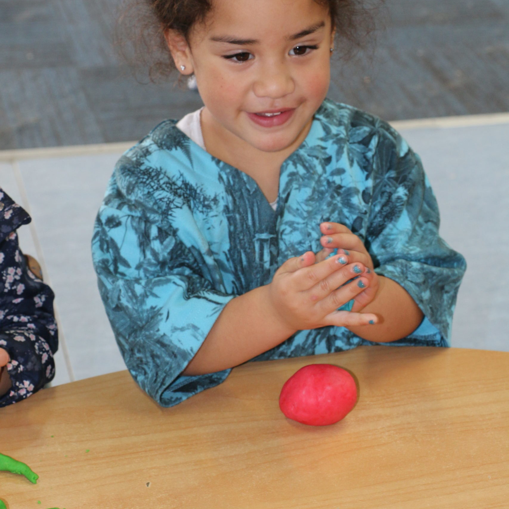 happy child playing with playdough